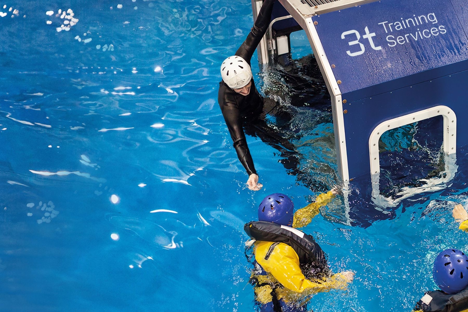 Two individuals in the water perform a safety exercise with one person reaching out from a cabin labeled 