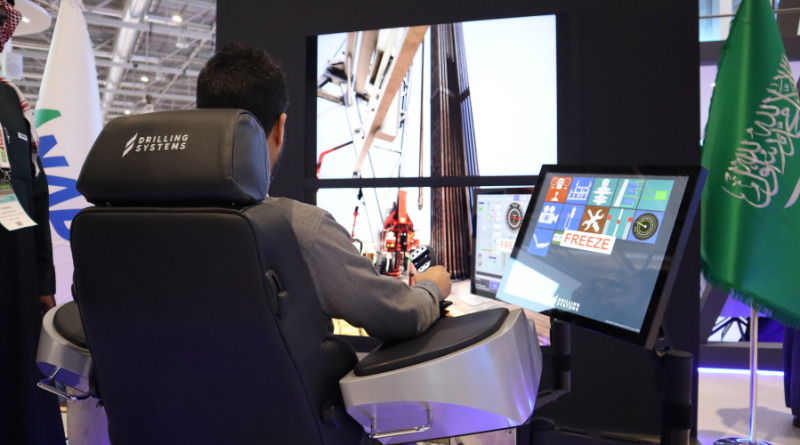 A person operates a drilling simulator with multiple screens displaying drilling operations, seated on a chair with the 