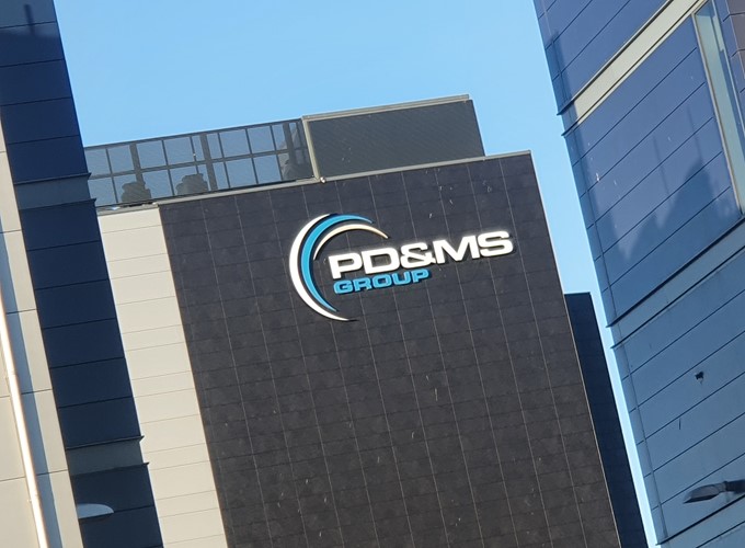 The exterior of a modern building with the logo and name 