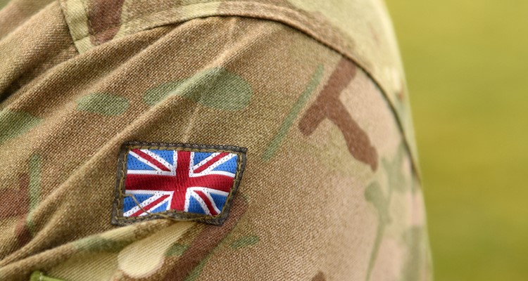 Close-up of a camouflage uniform sleeve featuring a Union Jack patch.