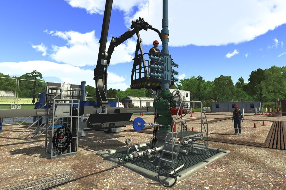 Workers operate equipment on an oil rig site with a crane lifting a worker in a cage. The surrounding area includes machinery, tools, and temporary buildings under a clear sky.