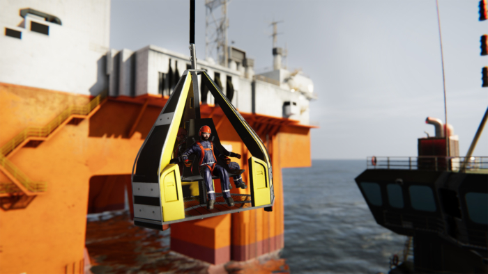 A worker in safety gear is seated in a yellow hoist basket, suspended over water, with an offshore oil platform in the background.