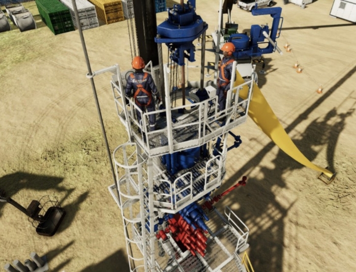 Two workers in safety gear are standing on a metal platform surrounded by industrial machinery at a construction or drilling site. Various equipment and supplies are visible in the background.