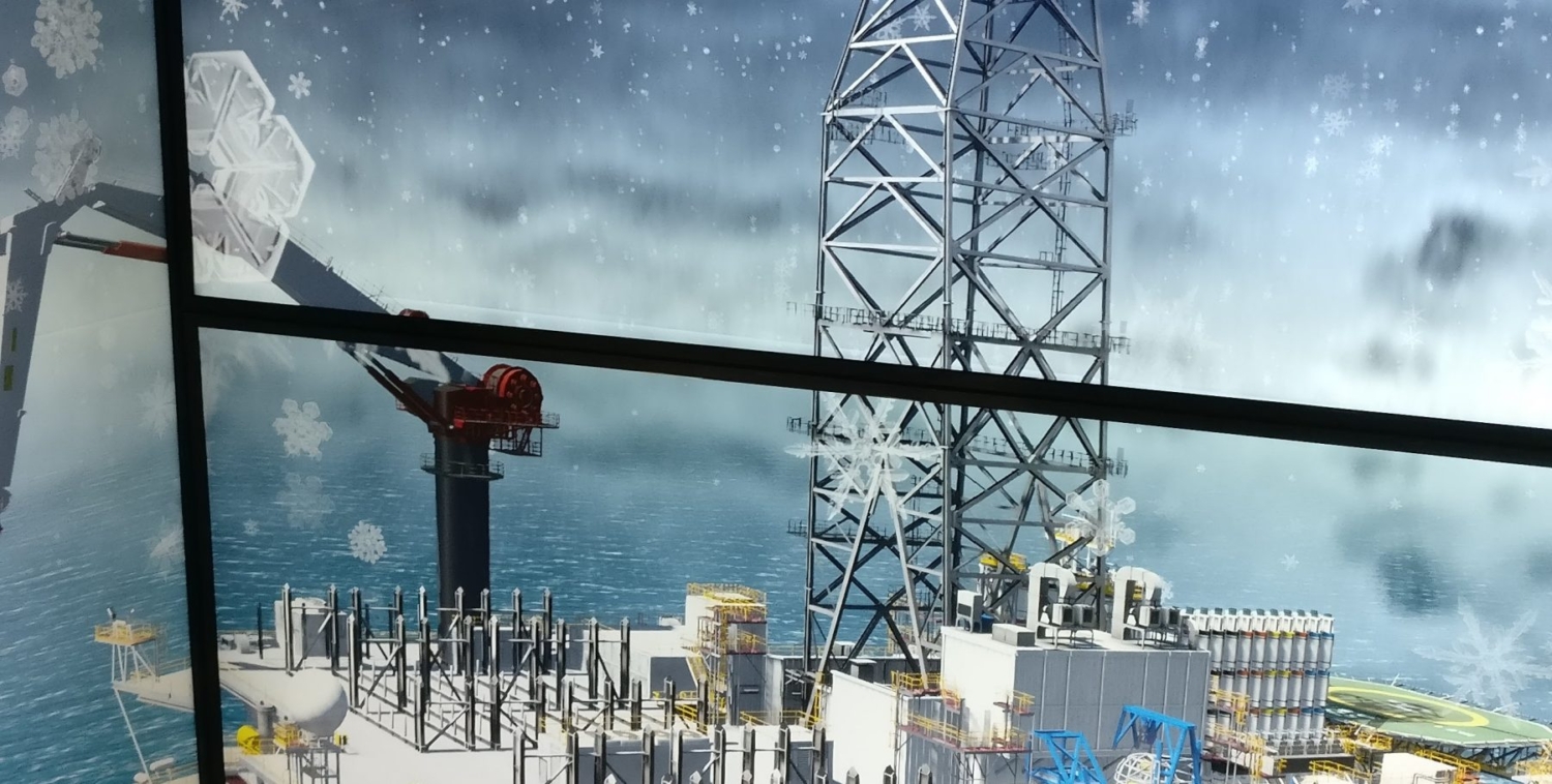 View of an offshore oil rig in the ocean, featuring a crane and various equipment on deck. Visible snowflakes suggest cold weather conditions.