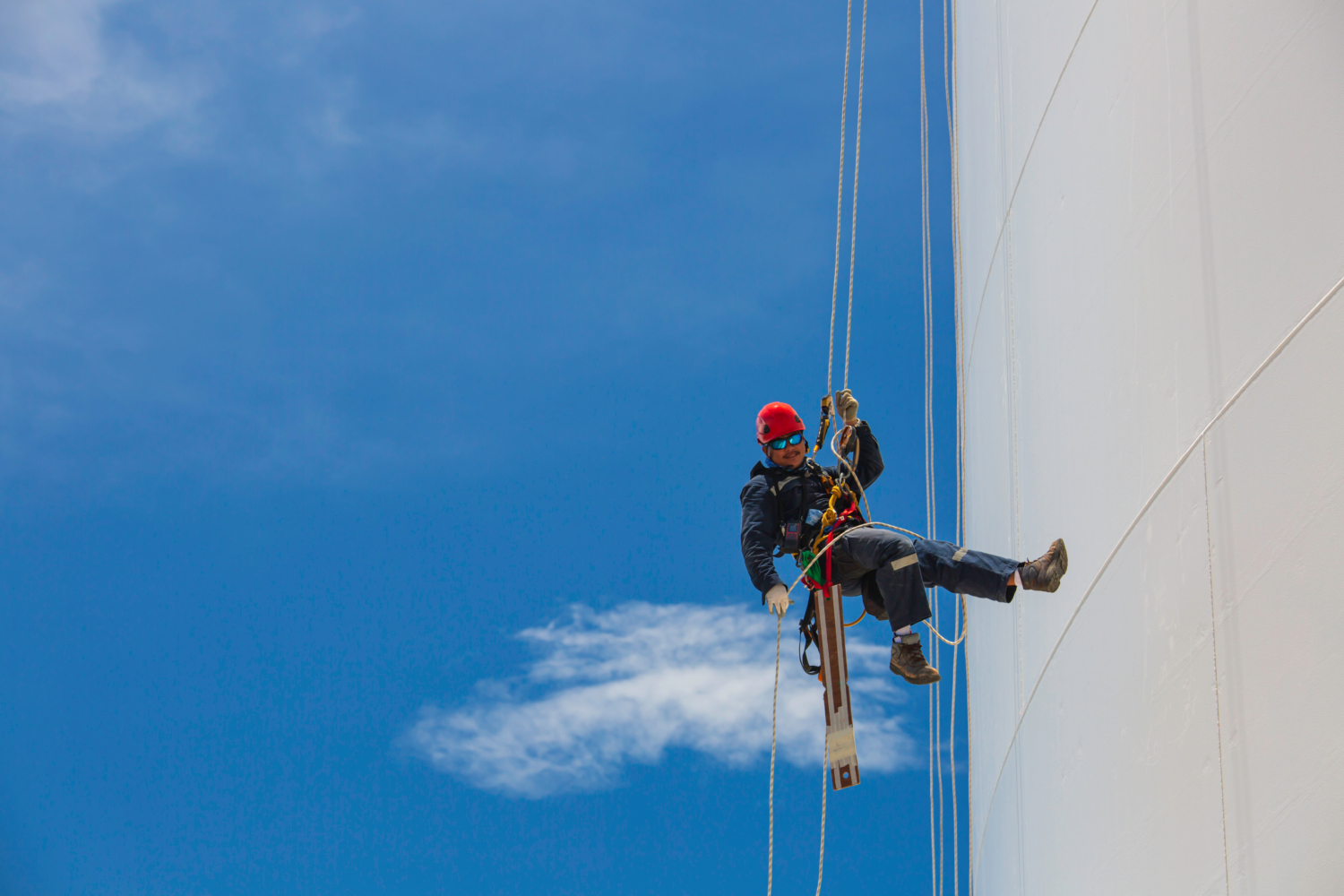 man doing rope access work on a wind turbine