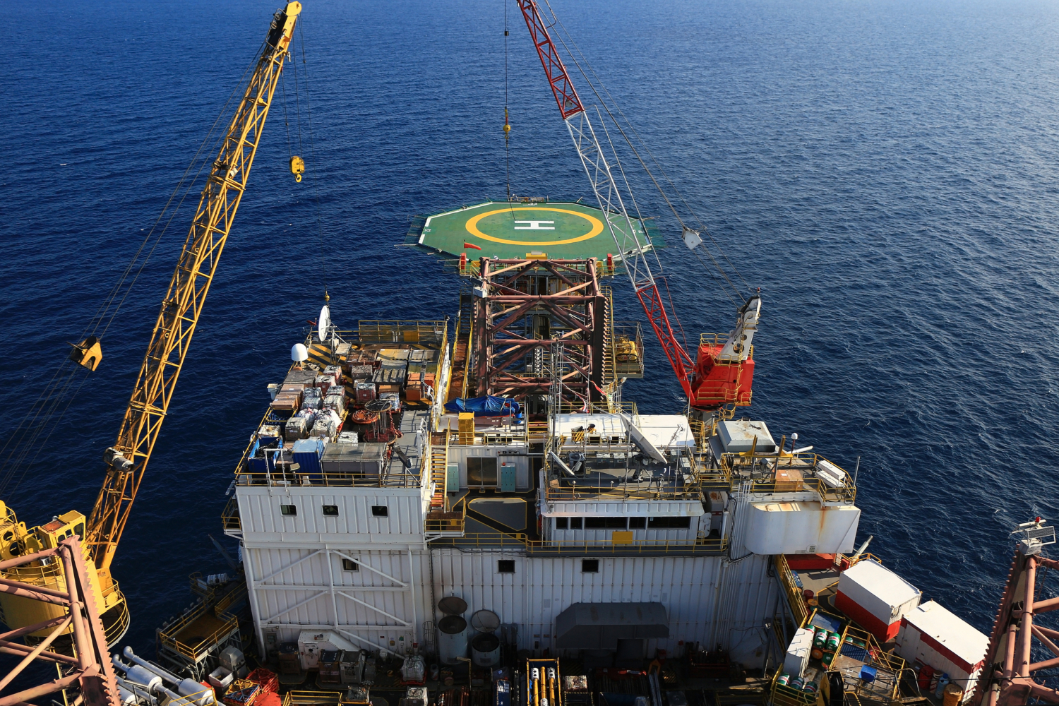 Birds eye view of oil and gas offshore platform with ocean in the background