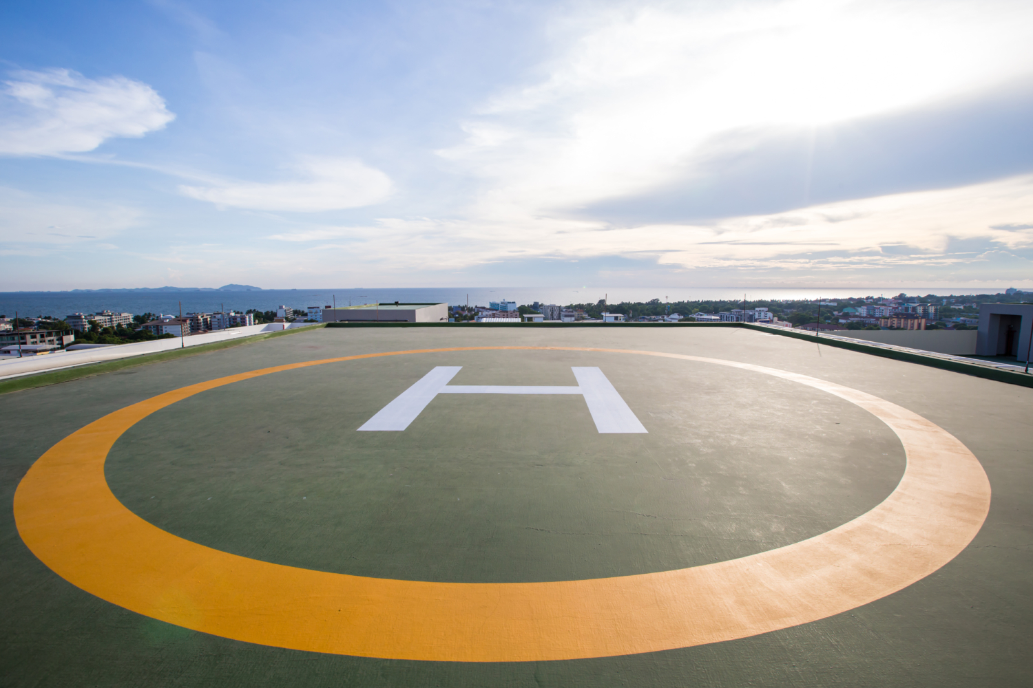 A rooftop helipad with a white 