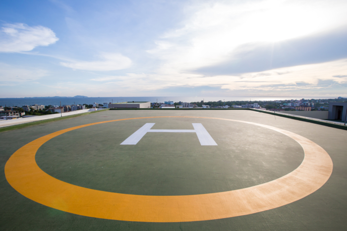 A rooftop helipad with a white 