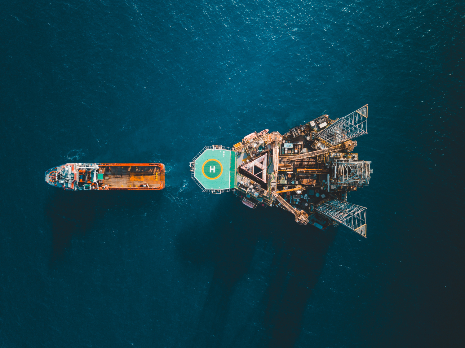 aerial bird eye view of boat and oil gas asset in the ocean
