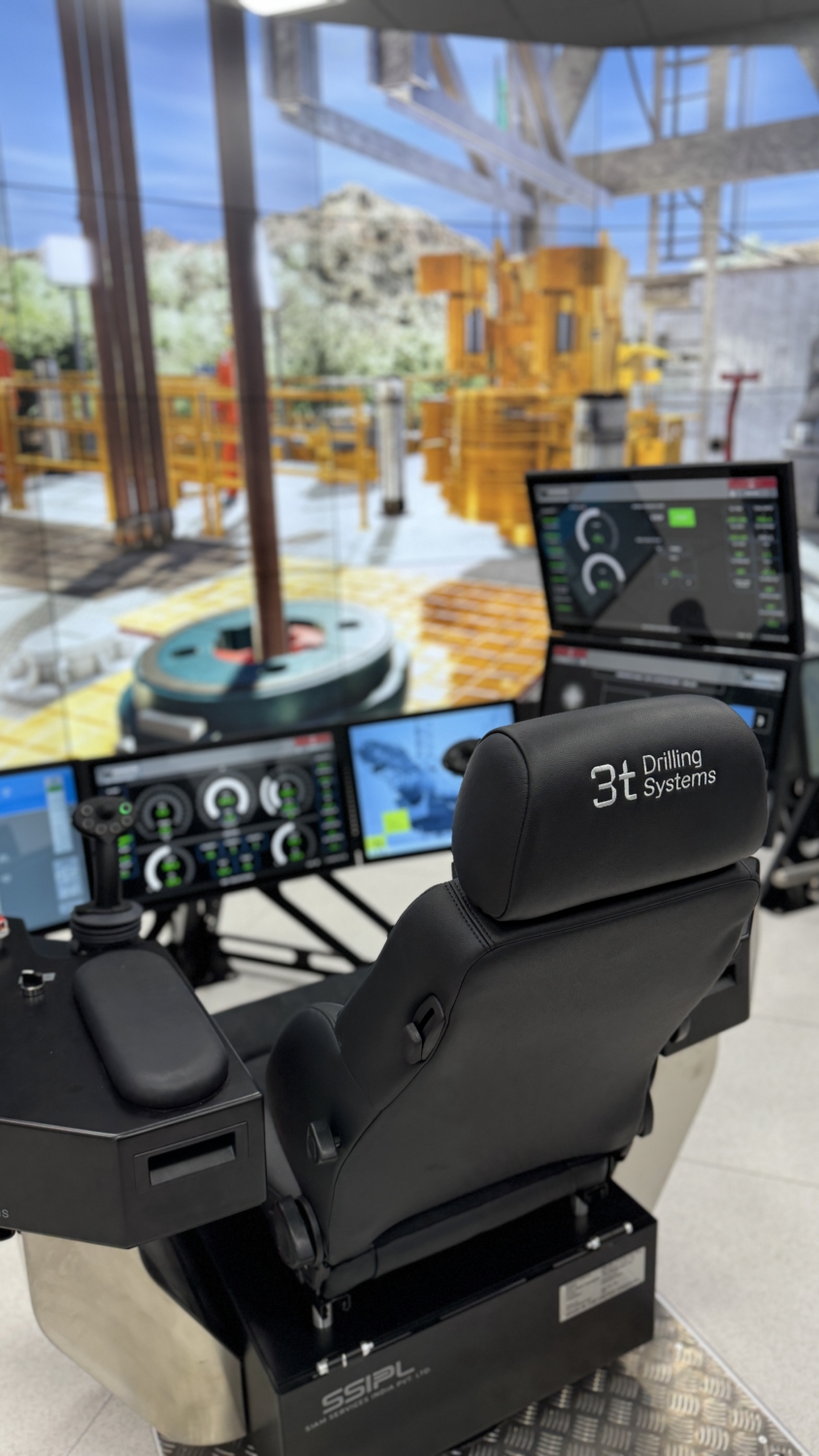 Picture from behind showing chair, controls and screens for drilling and well control simulator training