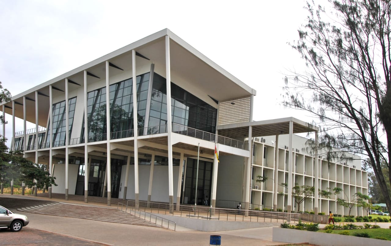 White two storey building with angular supporting columns and large glass windows